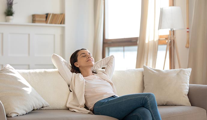 A person is relaxing at living room and enjoying fresh air