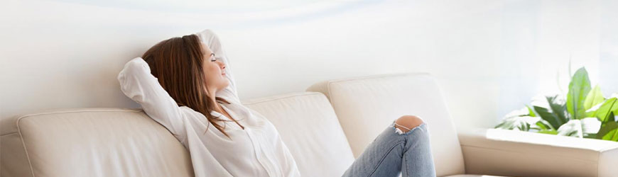 Woman relaxing indoors enjoying fresh and clean indoor air quality