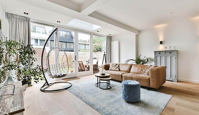 Cleaning living room with leather sofa and hanging chair